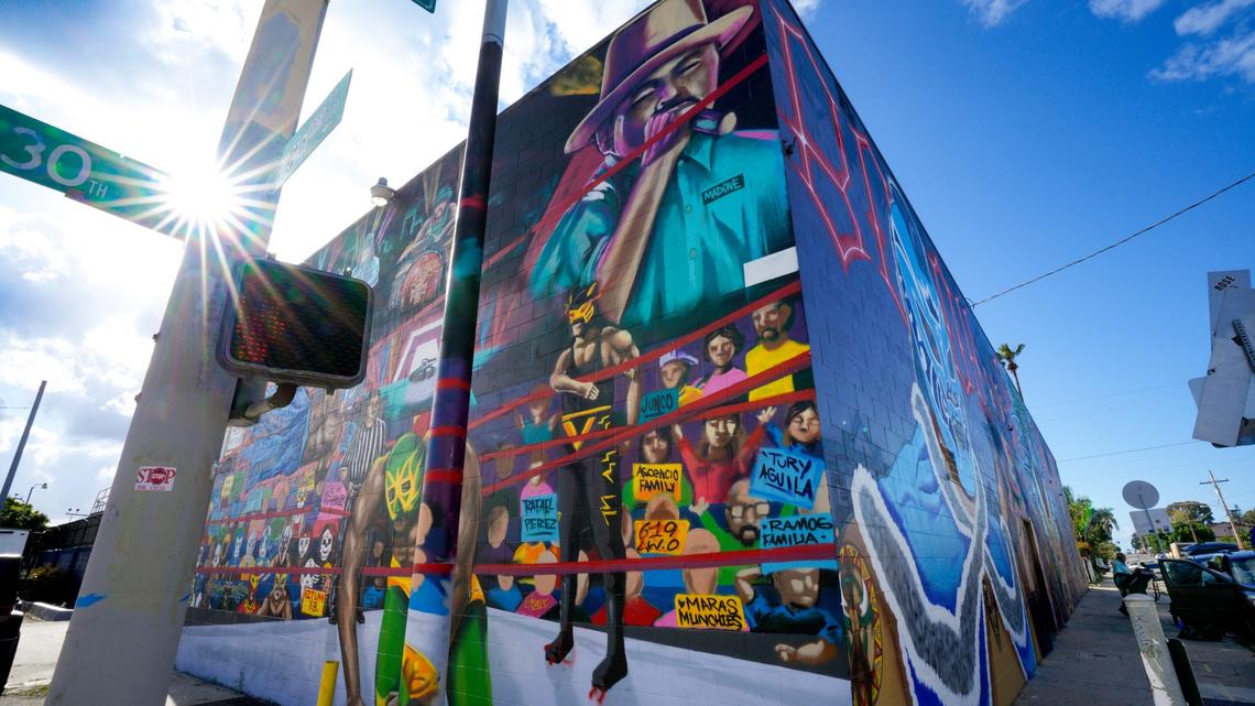 Large murals on the outside wall of a local San Diego recycling business on Commercial Street of various Mexican wrestlers, including Rey Mysterio Jr. and Dominik Mysterio.  (Nelvin C. Cepeda / The San Diego Union-Tribune)