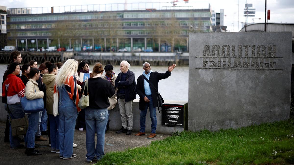 FILE PHOTO: Students from the U.S. attend a guided tour with Pierre Guillon de Prince, a 83-year-old descendant of a famous Nantes family whose ancestors were owners of ships transporting enslaved people, and Dieudonne Boutrin, a 59-year-old descendant of enslaved Africans in Martinique, president of the association La Coque Nomade-Fraternite, a human right association in Nantes which campaigns on slavery and reparations, at the Memorial to the Abolition of Slavery in Nantes, France, March 23, 2024. REUTERS/Stephane Mahe/File Photo
