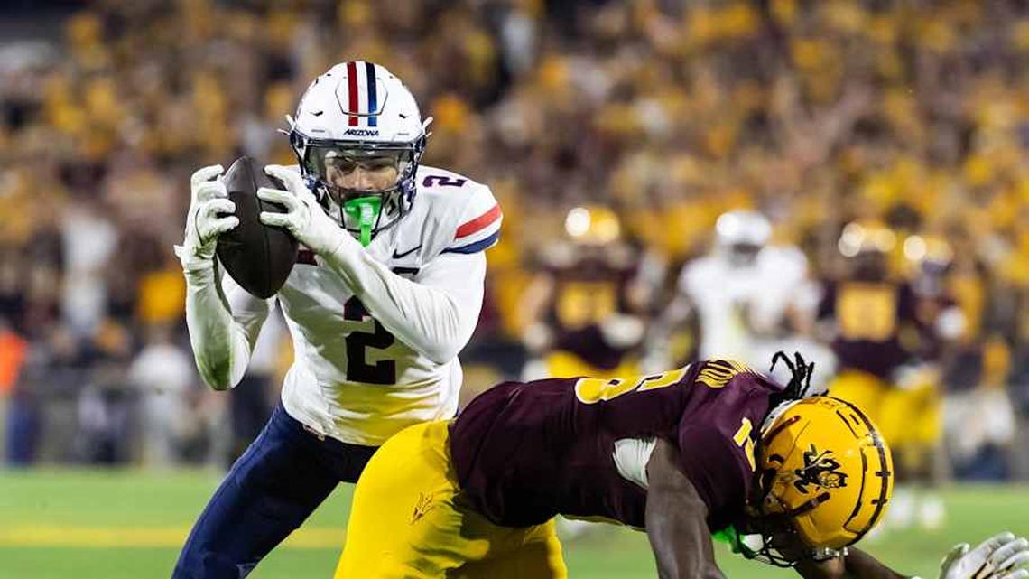  Nov 28, 2025; Tempe, Arizona, USA; Arizona Wildcats defensive back Treydan Stukes (2) intercepts the ball against Arizona State Sun Devils wide receiver Jaren Hamilton (16) in the second half during the 99th Territorial Cup at Mountain America Stadium. Mandatory Credit: Mark J. Rebilas-Imagn Images | Mark J. Rebilas-Imagn Images 