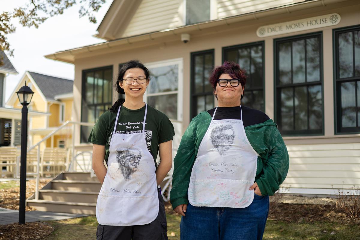 Sean Zheng, left, and Luis Oviedo, this year's house residents who oversee the all-comers Sunday brunch, outside the Dacie Moses House, Carleton College's cookie house in Northfield, Minn., March 31, 2026. For decades, Carleton College has kept a place where students and others can come, bake and share. (Liam James Doyle/The New York Times)