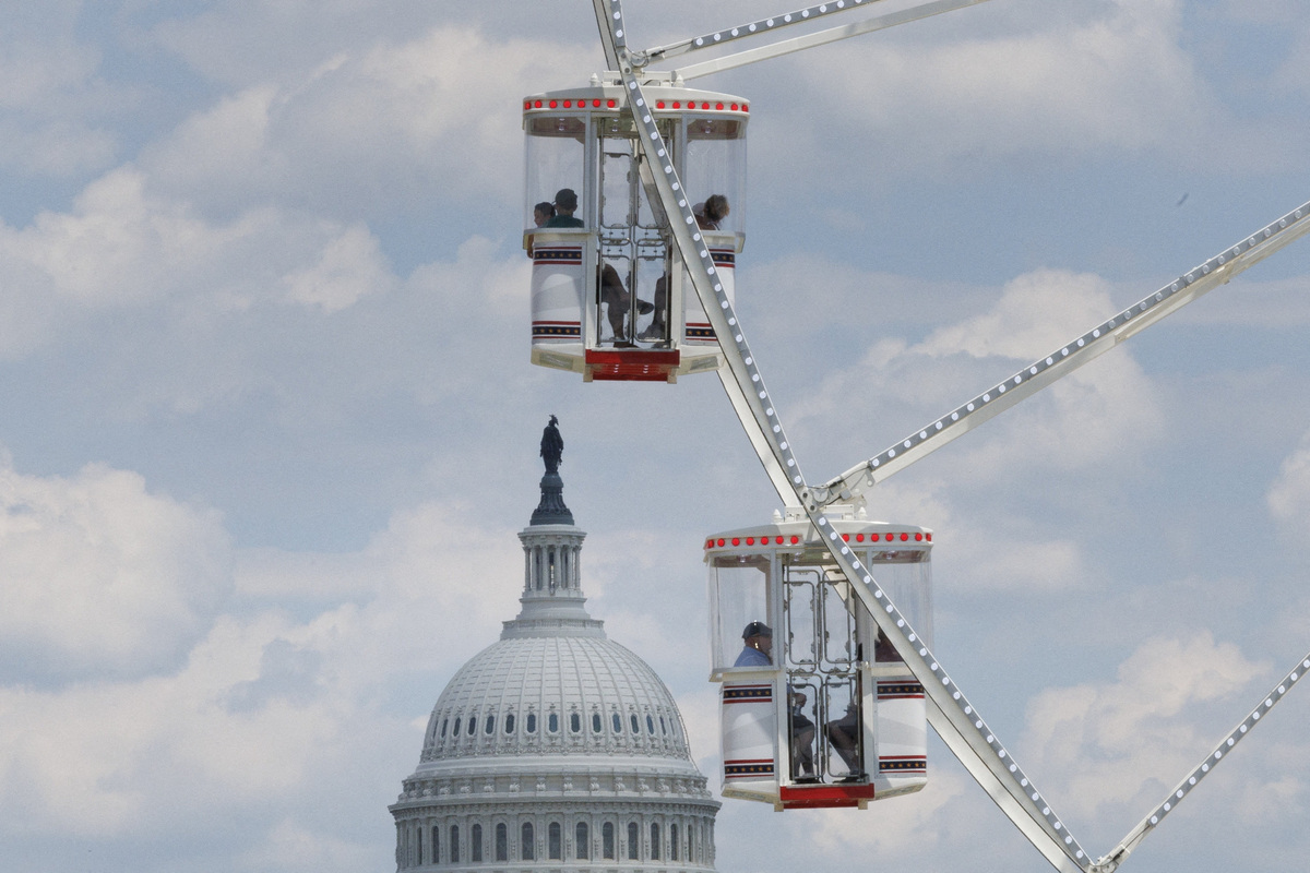Visitors ride the Ferris wheel near the U.S. Capitol at the Great American State Fair on the National Mall in Washington, D.C., U.S., June 25, 2026. REUTERS/Tom Brenner