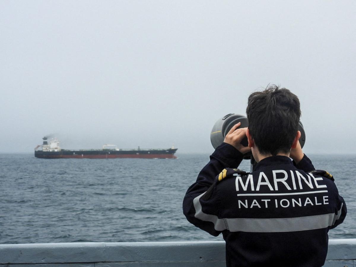 A French Navy personnel observes an oil tanker, subject to international sanctions and sailing from Russia, sailing in the Atlantic Ocean, in this handout obtained by Reuters on June 1, 2026. Marine Nationale/Handout via REUTERS