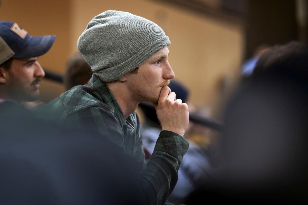 FILE -- CJ McDonald, who uses they/them pronouns, listens to Graham Platner, a Democratic candidate for the U.S. Senate, during a town hall at the Biddeford Performing Arts Center in Biddeford, Maine, Nov. 19, 2025. Some Gen Z men who voted for Donald Trump are dismayed by his time in office, but say they don't hear an appealing pitch from Democrats, either. (Gabe Souza/The New York Times)