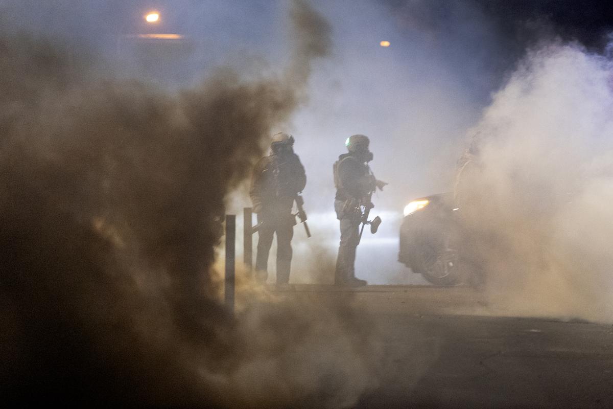  Federal agents launch tear gas at residents protesting a shooting incident on January 14, 2026 in Minneapolis, Minnesota. 