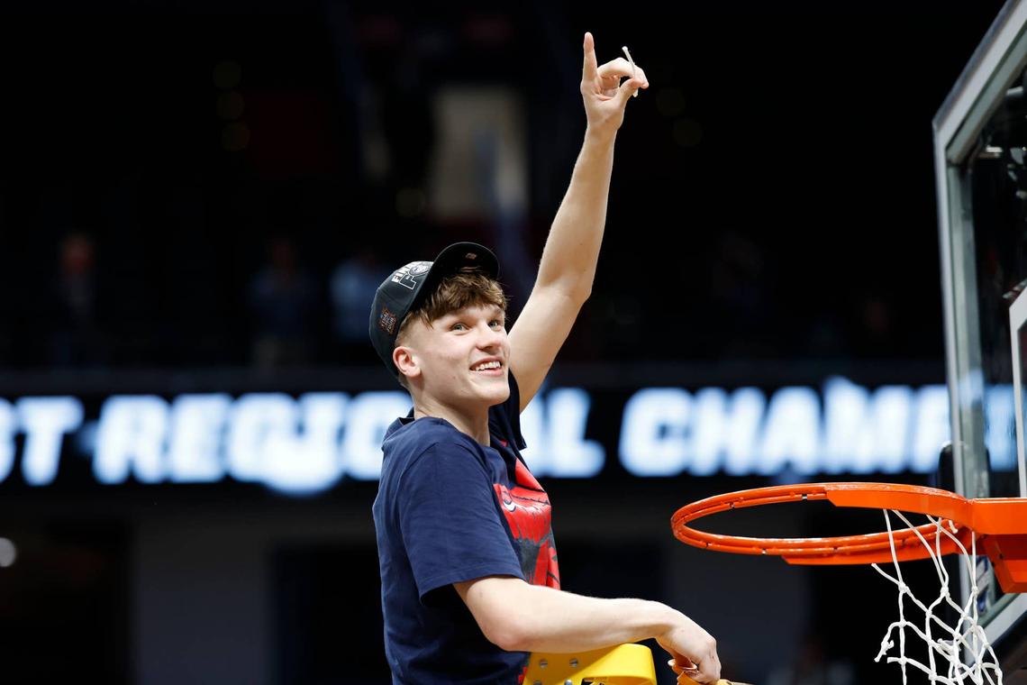  Mar 29, 2026; Washington, DC, USA; UConn Huskies guard Braylon Mullins (24) cuts down the net after defeating the Duke Blue Devils in an Elite Eight game of the East Regional of the men's 2026 NCAA Tournament at Capital One Arena. Mandatory Credit: Amber Searls-Imagn Images 