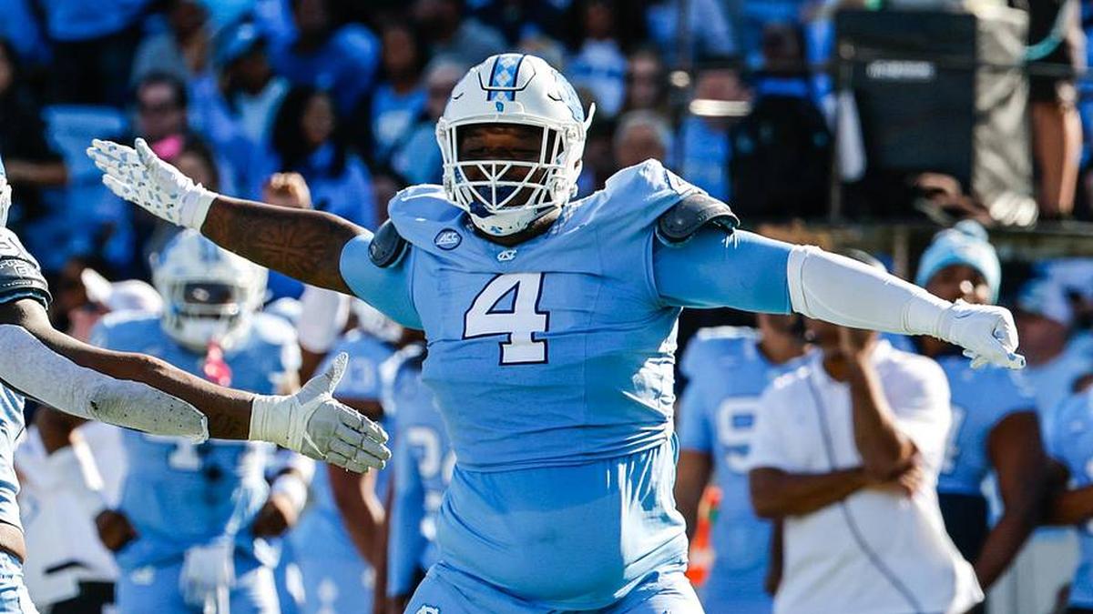  Oct 7, 2023; Chapel Hill, North Carolina, USA; North Carolina Tar Heels defensive lineman Travis Shaw (4) celebrates with teammate linebacker Kaimon Rucker (25) during the first half of the game against the Syracuse Orange at Kenan Memorial Stadium. Mandatory Credit: Jaylynn Nash-Imagn Images | Jaylynn Nash-Imagn Images 