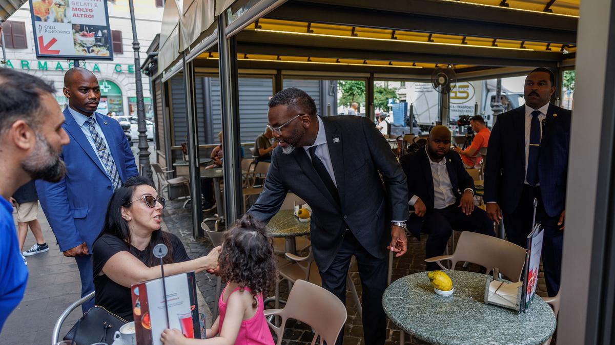 Chicago Mayor Brandon Johnson shakes hands with Marcella Mastria, of Chicago, at a cafe on May 29, 2026, in Rome. (Armando L. Sanchez/Chicago Tribune/TNS)