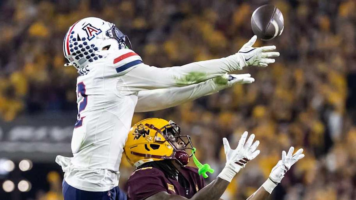  Nov 28, 2025; Tempe, Arizona, USA; Arizona Wildcats defensive back Treydan Stukes (2) intercepts the ball against Arizona State Sun Devils wide receiver Jaren Hamilton (16) in the second half during the 99th Territorial Cup at Mountain America Stadium. Mandatory Credit: Mark J. Rebilas-Imagn Images | Mark J. Rebilas-Imagn Images 