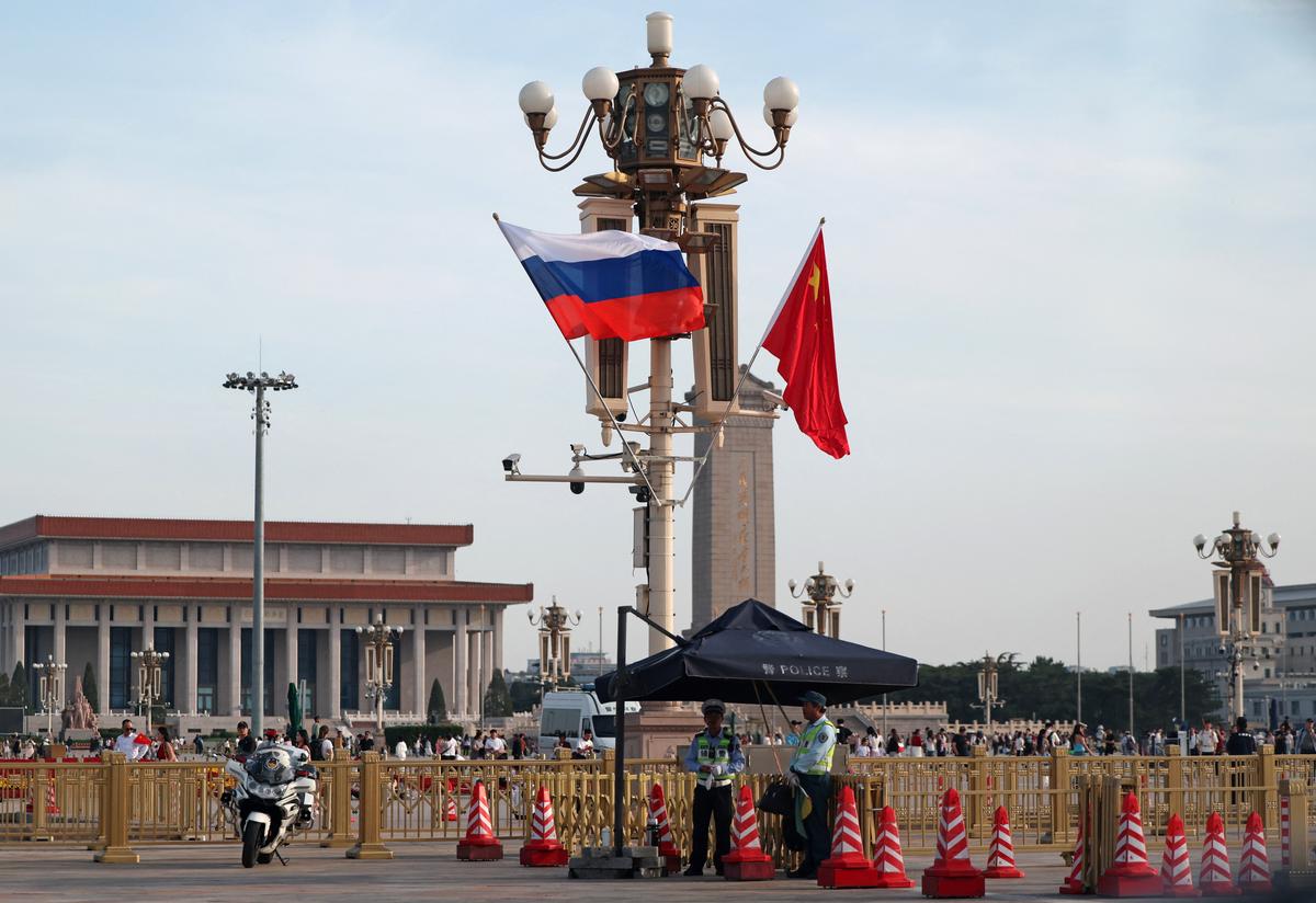 Police officers stand guard as Russia’s and China’s national flags fly in the Tiananmen Square, ahead of Russia's President Vladimir Putin visit to China, in Beijing, China, May 19, 2026. REUTERS/Maxim Shemetov