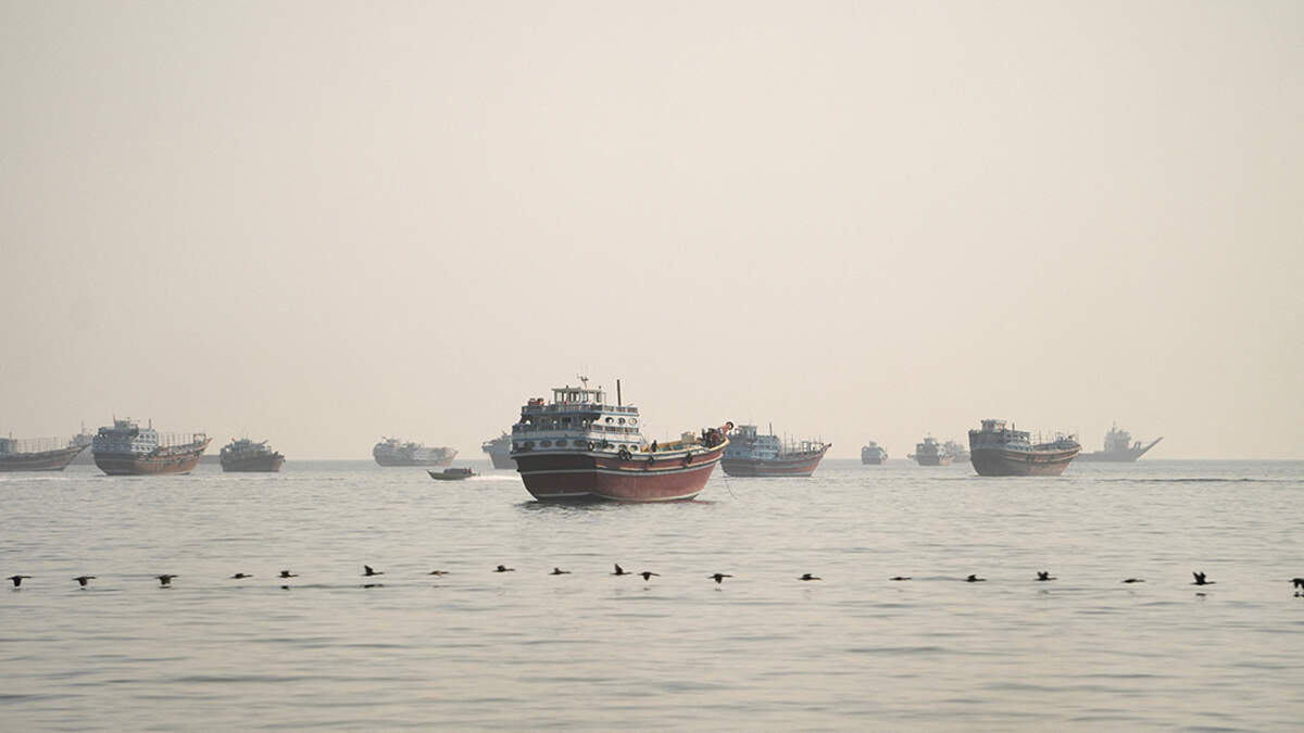 Vessels are anchored in the Strait of Hormuz, as seen from Musandam, Oman, on Wednesday. Iran’s top joint military command warned it would fire on any vessel attempting to pass through the strait, which has been largely closed for months, as attacks by both Tehran and Washington escalated for a second day.