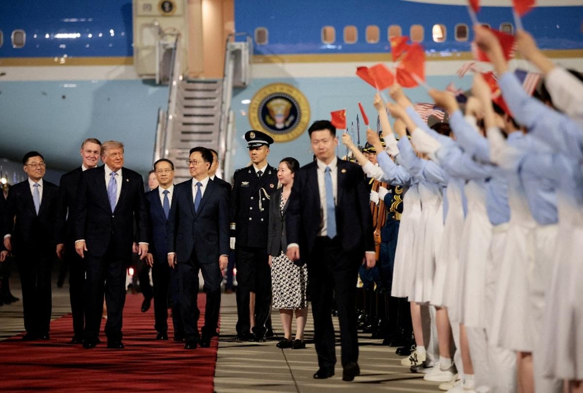 FILE PHOTO: U.S. President Donald Trump walks with Chinese Vice President Han Zheng during an arrival ceremony at Beijing Capital International Airport, in Beijing, China, May 13, 2026. REUTERS/Evan Vucci/File Photo