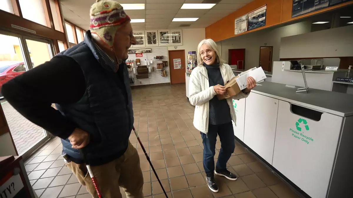 Hans Lehmann, then 91, left, converses with a fellow Carmel-by-the-Sea, California, resident at the post office on Jan. 12, 2024. Lehmann’s daily walks have given him lots of fodder for his Substack blog, "Walking My Ways." (Genaro Molina/Los Angeles Times/TNS)