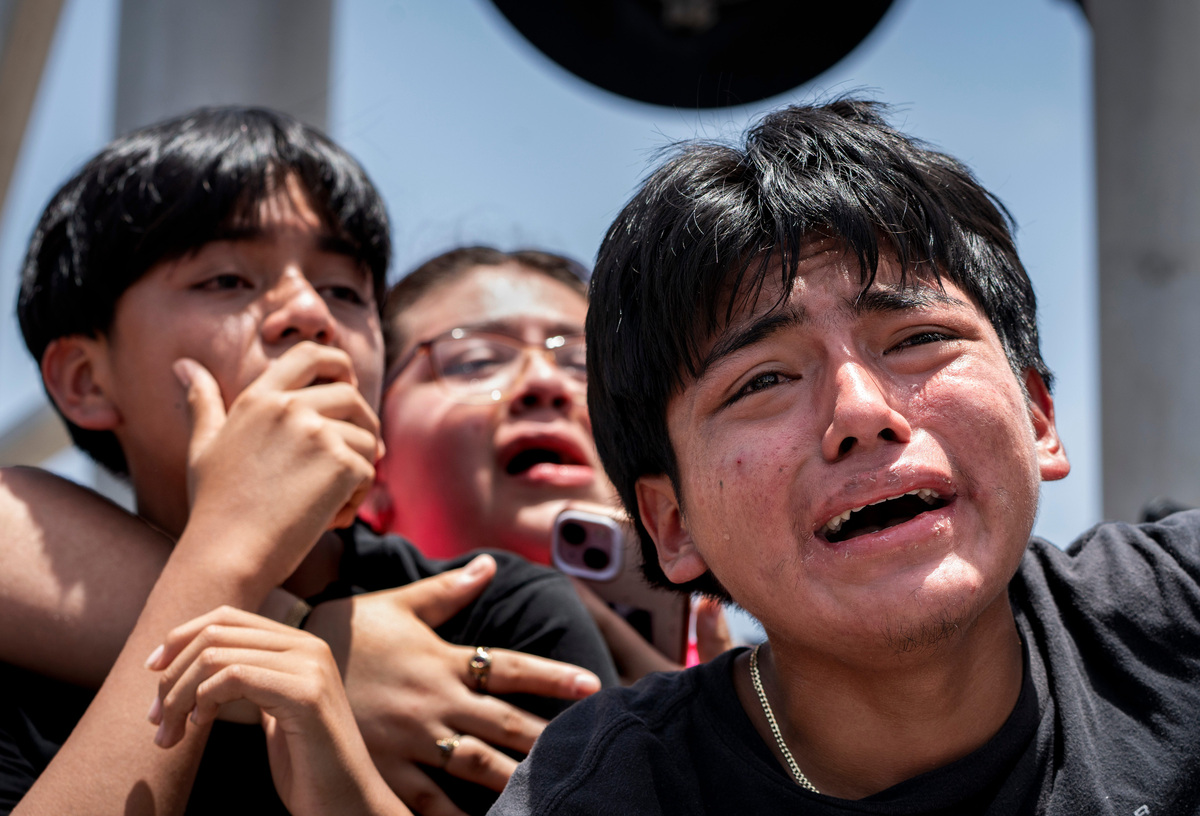 A boy cries with his family after ICE agents and FHP troopers arrested his father at the El Quetzal Panaderia Y Cafeteria on July 9, 2026 in Lake Worth Beach, Florida. CE said  Zapeta was an undocumented, had been deported multiple times, and had a criminal record from a 2012 DUI case in Palm Beach County.
