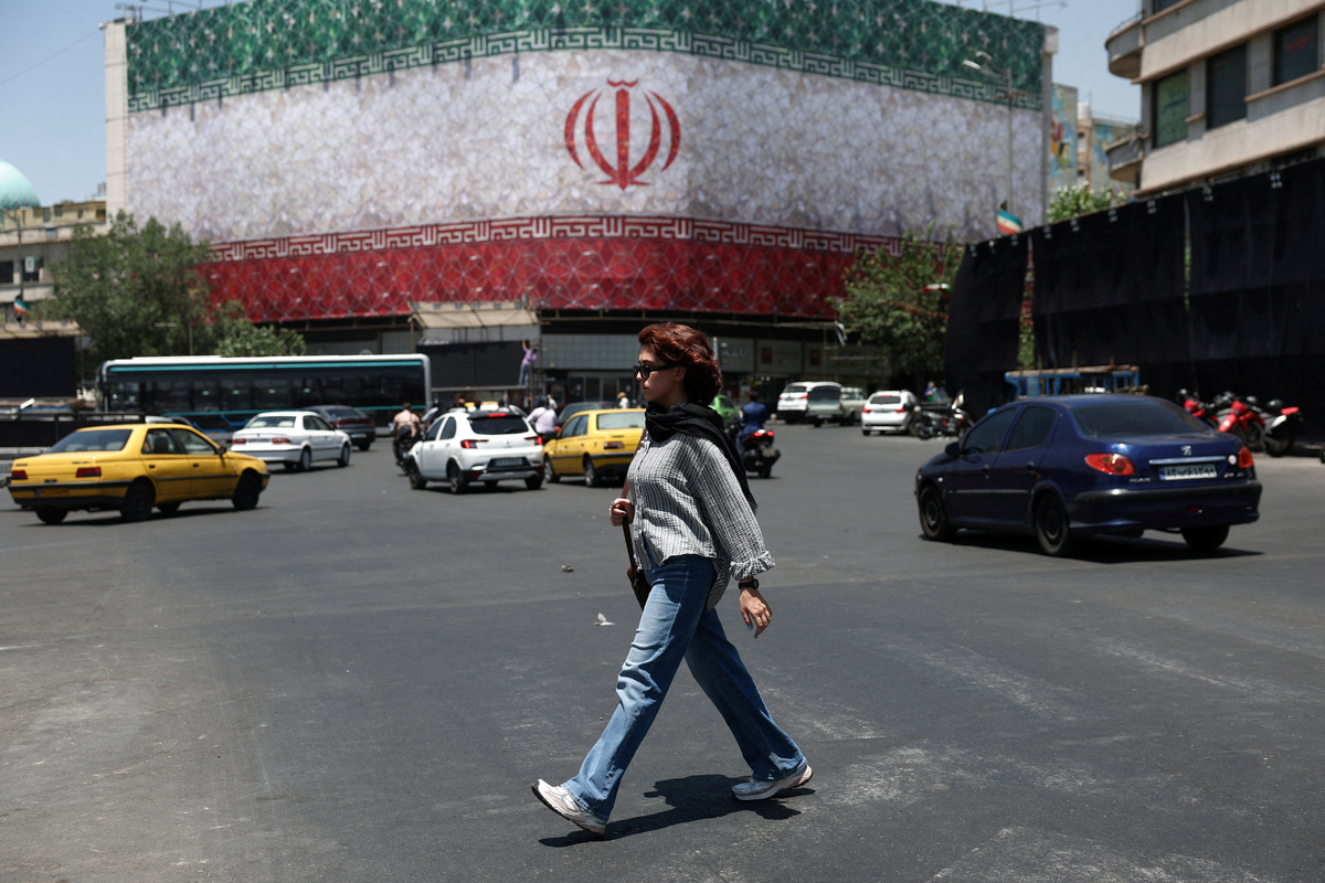A woman walks on a street in Tehran, Iran, June 14, 2026. Majid Asgaripour/WANA (West Asia News Agency) via REUTERS
