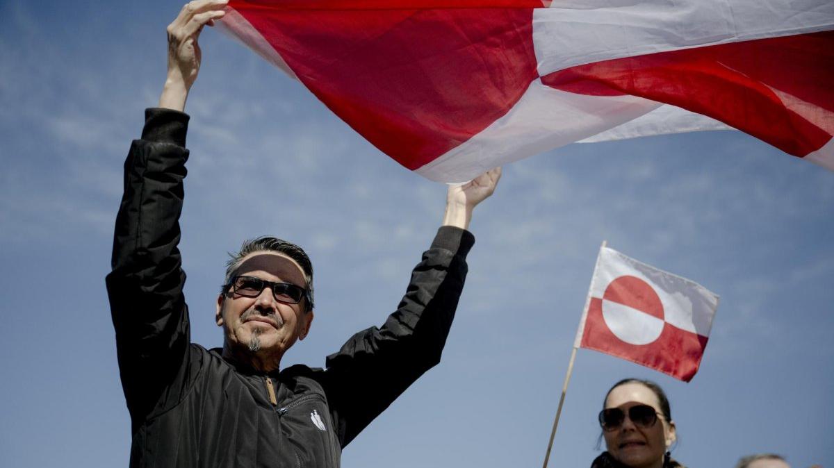 Demonstrators hold signs and wave flags during a protest outside the U.S. consulate in Nuuk, Greenland, Friday. The new diplomatic building officially opened earlier in the day amid tensions over American interests in Greenland. Photo by Oscar Scott Carl/EPA