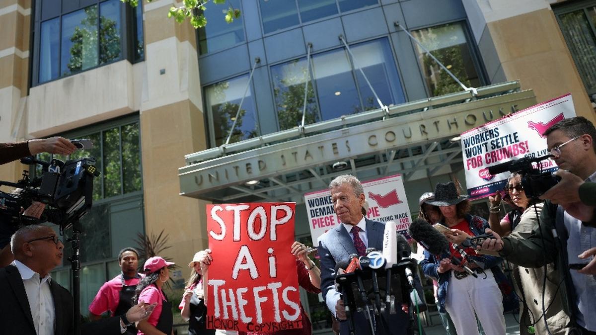 Elon Musk's attorney Marc Toberoff speaks to the press as demonstrators hold placards outside the federal courthouse, as the trial in Elon Musk's lawsuit over OpenAI's for-profit conversion continues, in Oakland, California, U.S., May 18, 2026. REUTERS/Manuel Orbegozo
