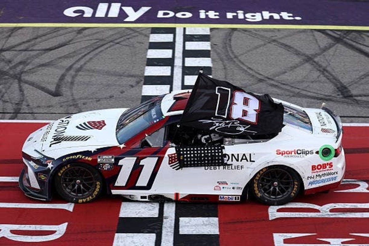  Denny Hamlin at the start/finish line after winning at Michigan, holding a Kyle Busch Tribute Flag. (Photo by Brett Farmer/Getty Images) (Photo by Brett Farmer/Getty Images)