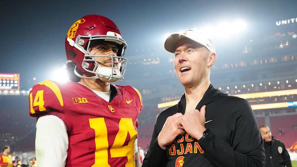  Nov 29, 2025; Los Angeles, California, USA; Southern California Trojans quarterback Jayden Maiava (14) and head coach Lincoln Riley react after the game against the UCLA Bruins at United Airlines Field at Los Angeles Memorial Coliseum. Mandatory Credit: Kirby Lee-Imagn Images | Kirby Lee-Imagn Images 