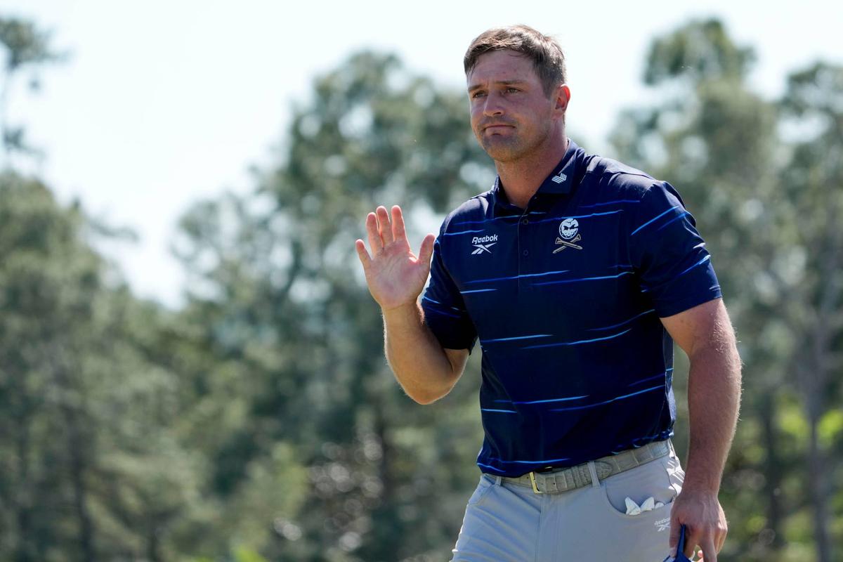  Apr 9, 2026; Augusta, Georgia, USA; Bryson DeChambeau acknowledges patrons as he walks off the 18th green during the first round of the Masters Tournament at Augusta National Golf Club. Mandatory Credit: Kyle Terada-Imagn Images 