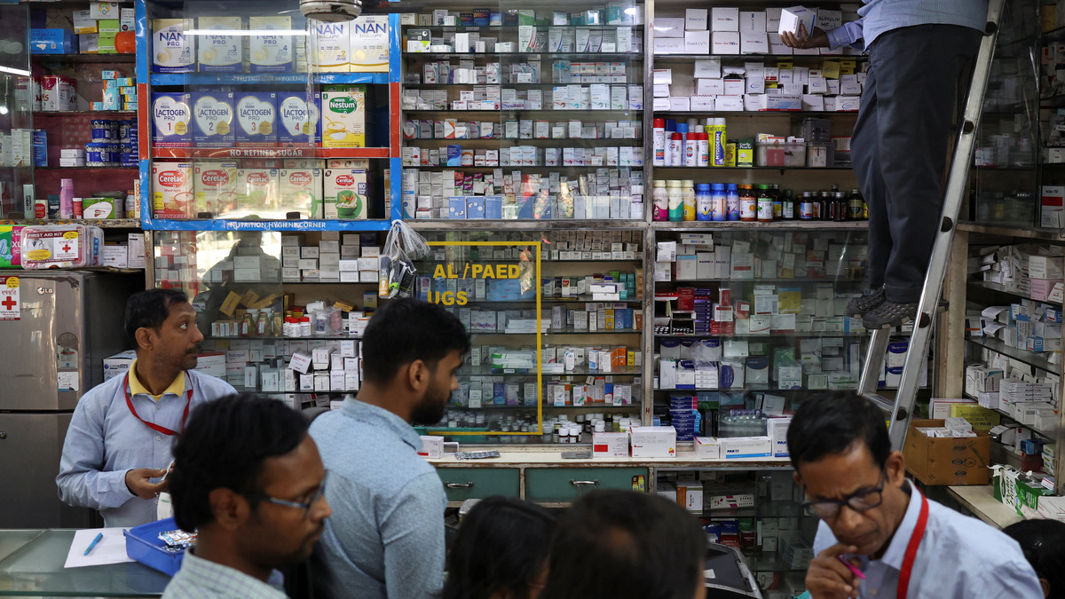 Pharmacists sort and sell medicines to customers inside a pharmacy in Kolkata, India, February 2, 2026. REUTERS/Sahiba Chawdhary