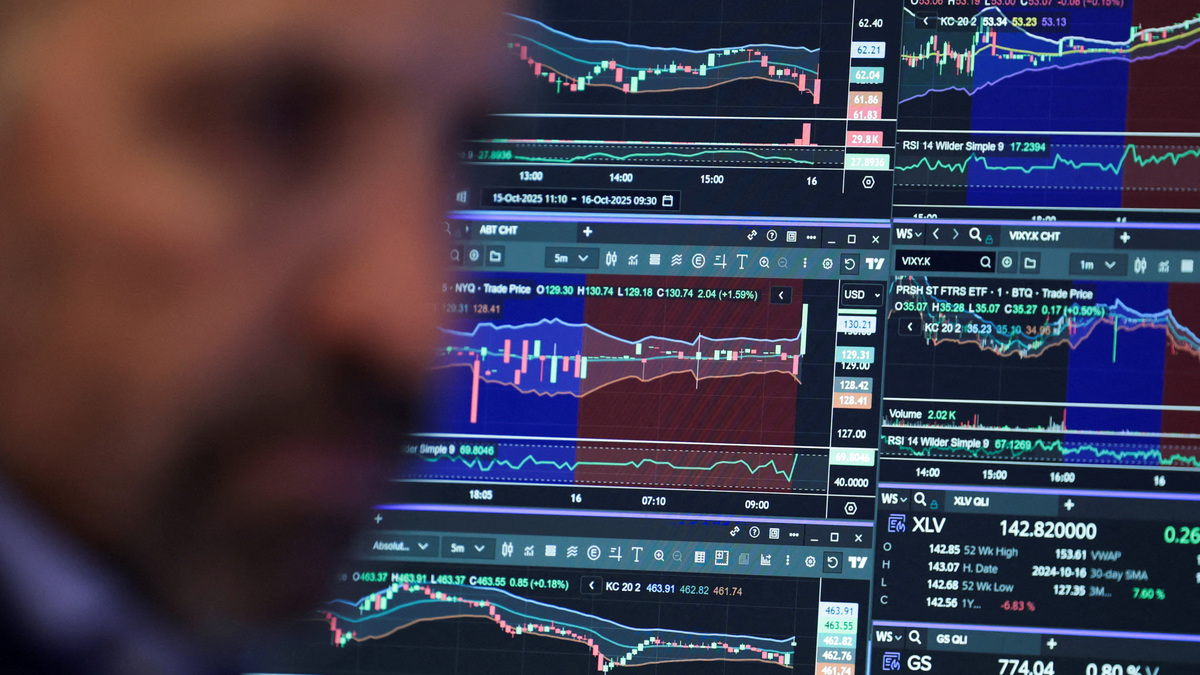 FILE PHOTO: A trader works on the floor at the New York Stock Exchange in New York City, U.S., October 16, 2025. REUTERS/Jeenah Moon/File Photo