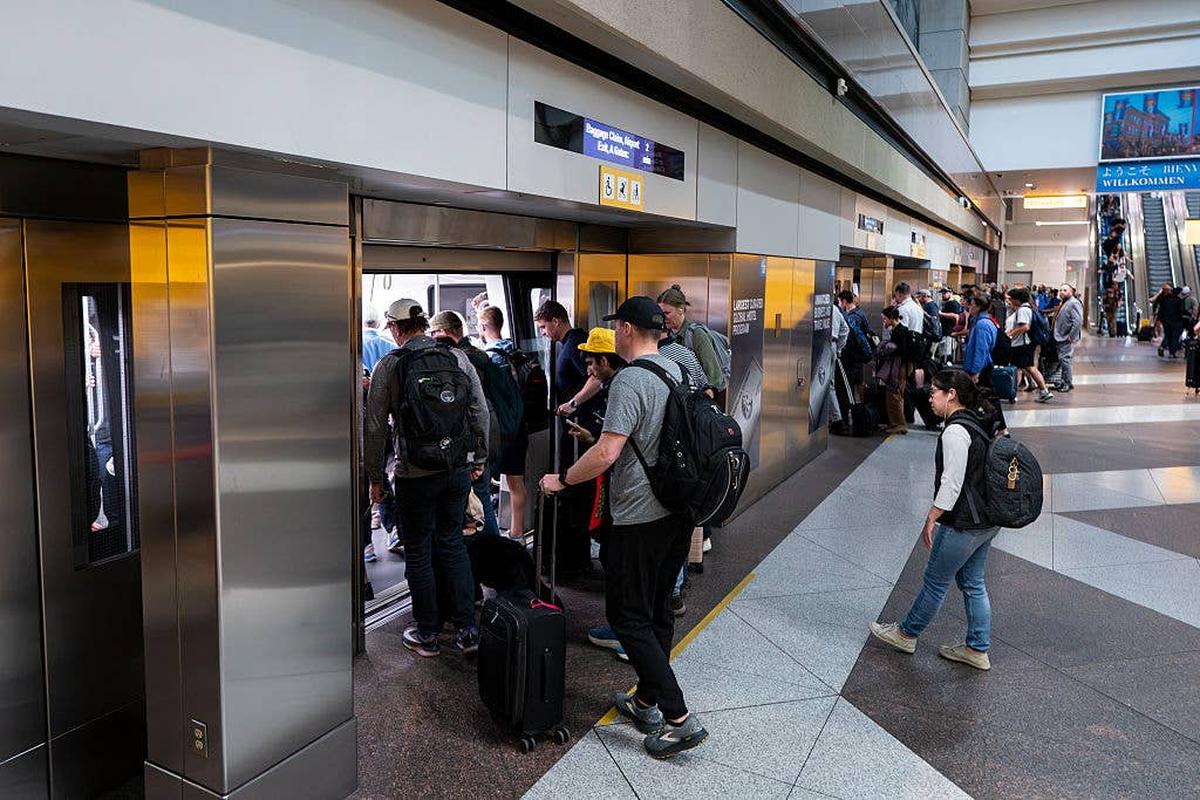 Travelers board the Automated Guideway Transit System (AGTS) people mover at Denver International Airport (DEN) on March 20, 2026, in Denver, Colorado.