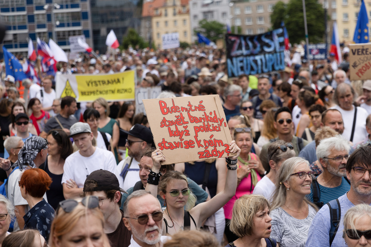 A person displays a sign reading "Will it be necessary to build barricades when politicians turn their backs on us?" during a protest rally in support of public media as the Czech government plans to revamp and cut funding for Czech TV and Czech Radio, in Prague, Czech Republic, June 21, 2026. REUTERS/Eva Korinkova
