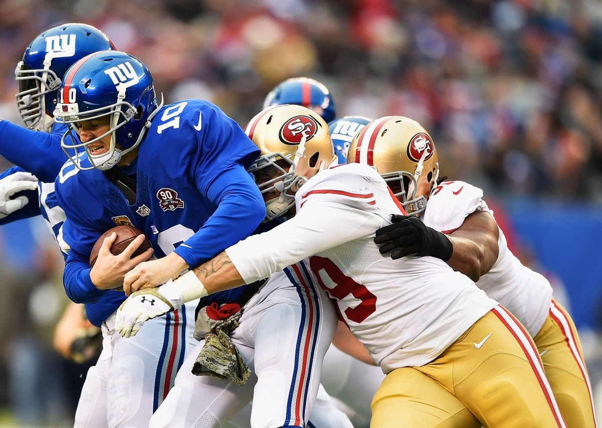  EAST RUTHERFORD, NJ - NOVEMBER 16: (R-L) Aaron Lynch #59 and Aldon Smith #99 of the San Francisco 49ers sack Eli Manning #10 of the New York Giants at MetLife Stadium on November 16, 2014 in East Rutherford, New Jersey. (Photo by Al Bello/Getty Images) 