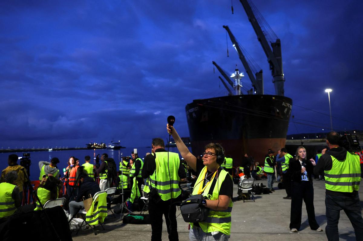 Members of the media work at the port of Granadilla de Abona following the arrival of the cruise ship MV Hondius after being affected by a hantavirus outbreak, in Tenerife, Spain, May 10, 2026. REUTERS/Hannah McKay