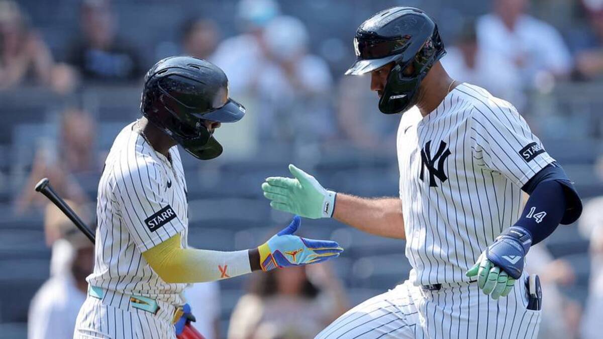  New York Yankees designated hitter Amed Rosario (14) celebrates his solo home run against the Detroit Tigers with second baseman Jazz Chisholm Jr. (13) during the ninth inning at Yankee Stadium. | IMAGN IMAGES via Reuters Connect 