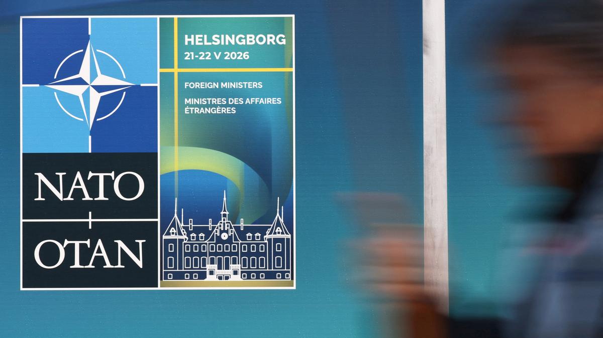 A pedestrian walks past a sign for the NATO foreign ministers' meeting in Helsingborg, Sweden, May 20, 2026. REUTERS/Tom Little