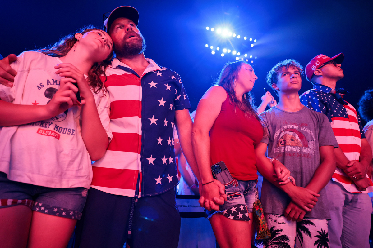 People listen to "God Bless America" ahead of a Fourth of July rally featuring U.S. President Donald Trump to mark the 250th anniversary of U.S. independence, in Washington, D.C., U.S., July 4, 2026. REUTERS/Jonathan Ernst