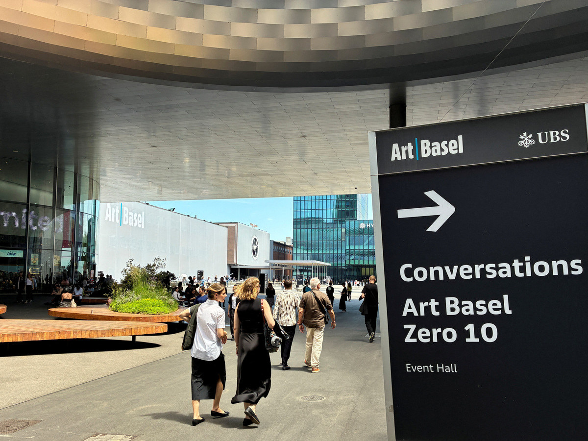 Visitors walk by a sign pointing to the Art Basel Zero 10 exhibition, June 17, 2026. Picture taken with a mobile phone. REUTERS/Marleen Kaesebier