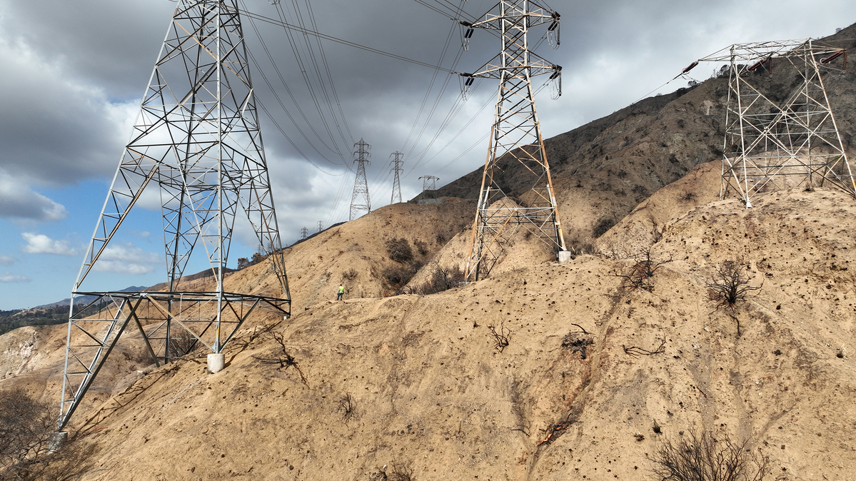 Investigators view the Edison electrical lines, transmission towers and surrounding area, which is a location that is being investigated as the possible origin of the Eaton fire in Eaton Canyon in Altadena, California on Tuesday, Feb. 11, 2025. (Allen J. Schaben/Los Angeles Times/TNS)