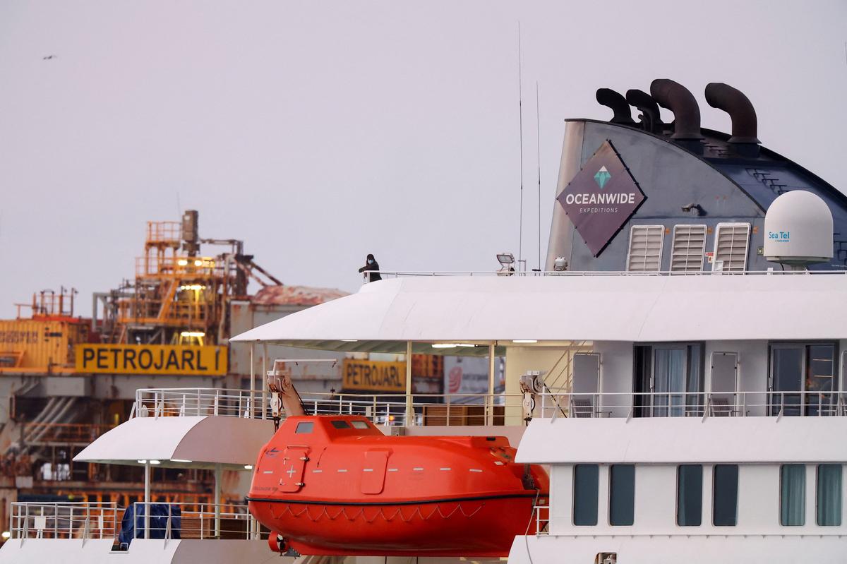 A person wearing a mask stands aboard the cruise ship MV Hondius at the port of Granadilla de Abona after being affected by a hantavirus outbreak, in Tenerife, Spain, May 10, 2026. REUTERS/Hannah McKay