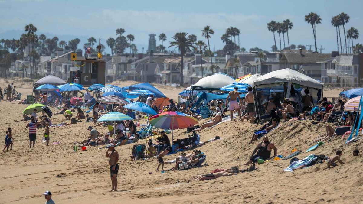 Beachgoers hang out on the sand near the Balboa Pier, where new rules limit the use of shade structures to no more than six feet wide or long, in Newport Beach on Saturday, June 20, 2026. (Photo by Jeff Antenore, Orange County Register/SCNG)