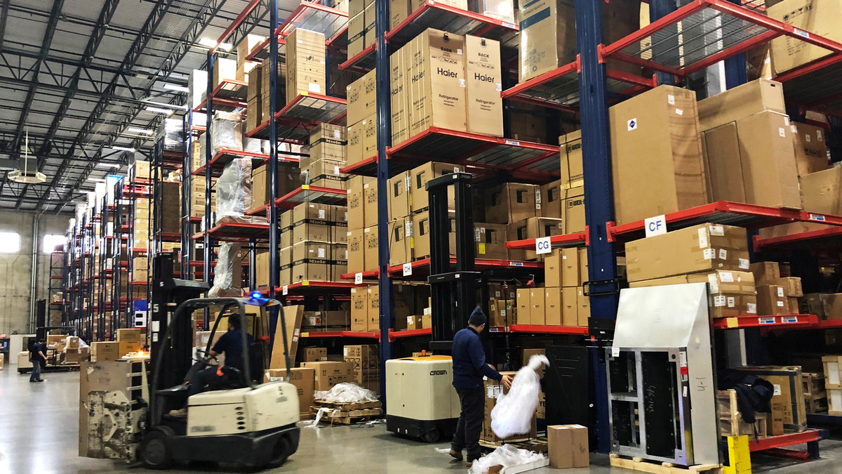 Warehouse workers deal with inventory stacked up to the ceiling at an ABT Electronics Facility in Glenview, Illinois, U.S. December 4, 2018. REUTERS/Richa Naidu