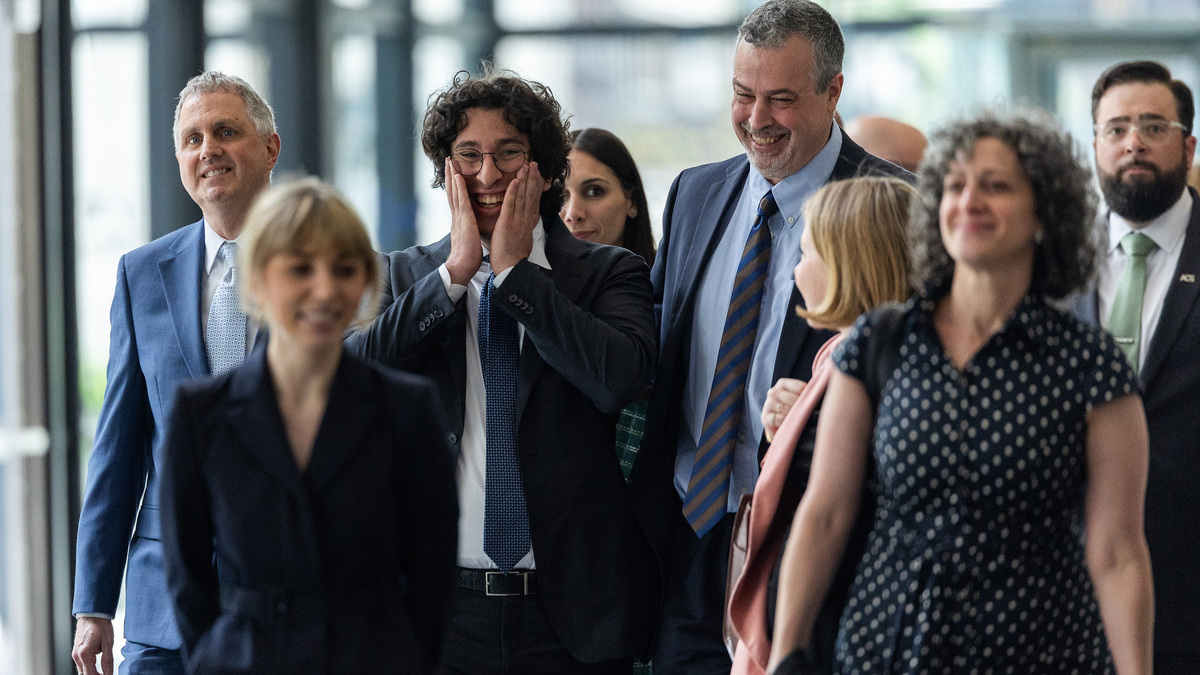 Michael Rabbitt, from left, Kat Abughazaleh, and Andre Martin laugh together as they leave the courtroom at Dirksen U.S. Courthouse following a hearing in the Broadview Six case in Chicago’s Loop, May 21, 2026. (Josh Boland/Chicago Tribune/TNS)