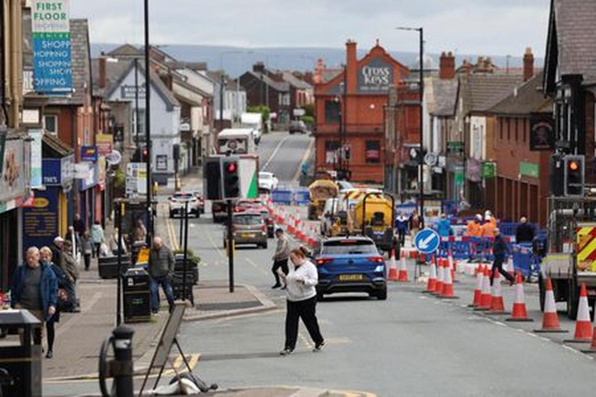 People walk along the high street ahead of the Makerfield by-election, triggered by Labour MP Josh Simons, who resigned as a minister in March, in Ashton-in-Makerfield, Britain, May 20, 2026. REUTERS/Temilade Adelaja