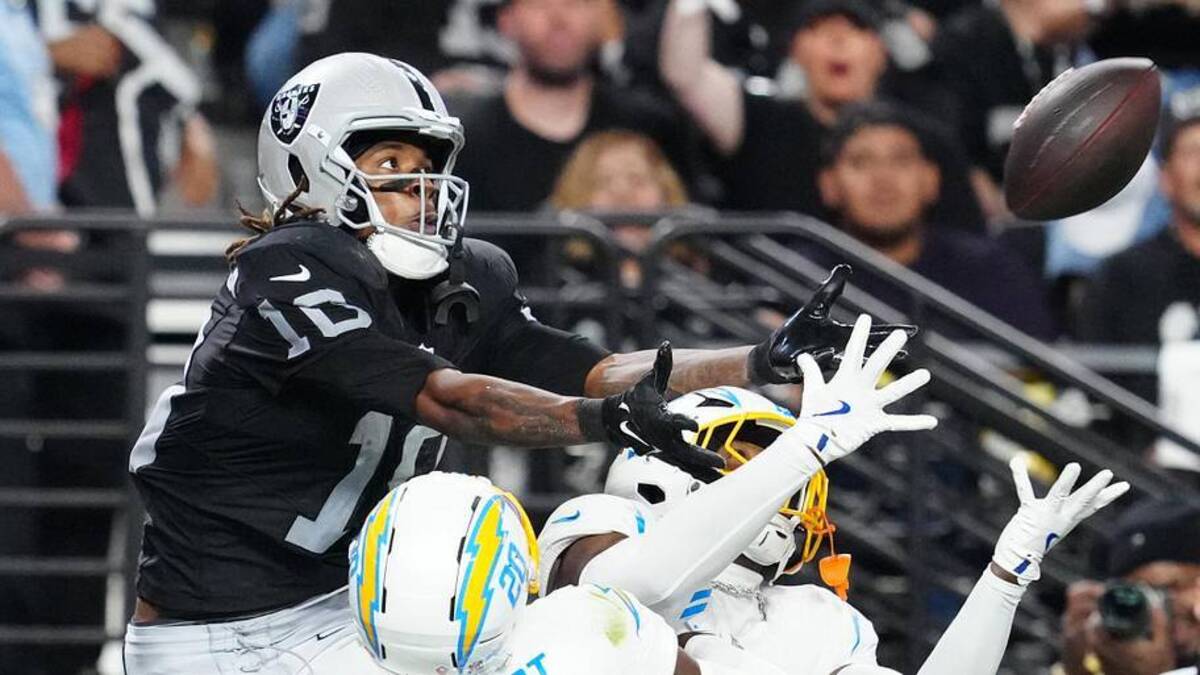  Sep 15, 2025; Paradise, Nevada, USA; Las Vegas Raiders wide receiver Dont'e Thornton Jr. (10) attempts to make a catch as Los Angeles Chargers cornerback Cam Hart (20) and Los Angeles Chargers safety Tony Jefferson (23) defend during the second quarter at Allegiant Stadium. Mandatory Credit: Stephen R. Sylvanie-Imagn Images | Stephen R. Sylvanie-Imagn Images 