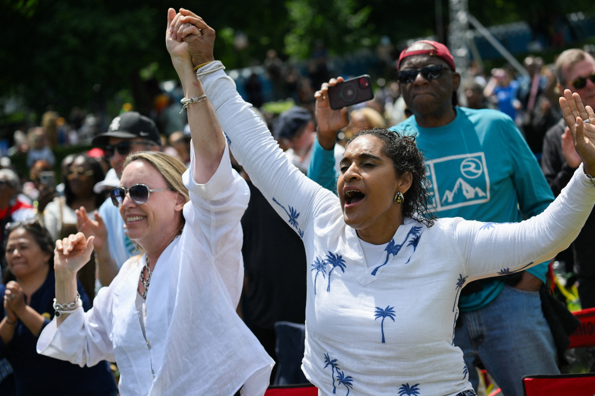 People react, as supporters attend a watch party at the Midway Plaisance Park for the opening of the Obama Presidential Center in Chicago, Illinois, U.S., June 18, 2026. REUTERS/Joshua Lott