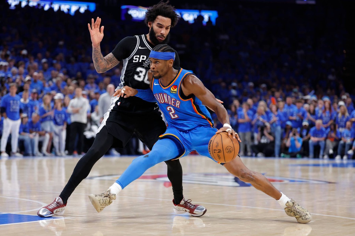  Oklahoma City Thunder guard Shai Gilgeous-Alexander controls the ball against San Antonio Spurs forward Julian Champagnie during the 2026 Western Conference finals. Alonzo Adams-Imagn Images