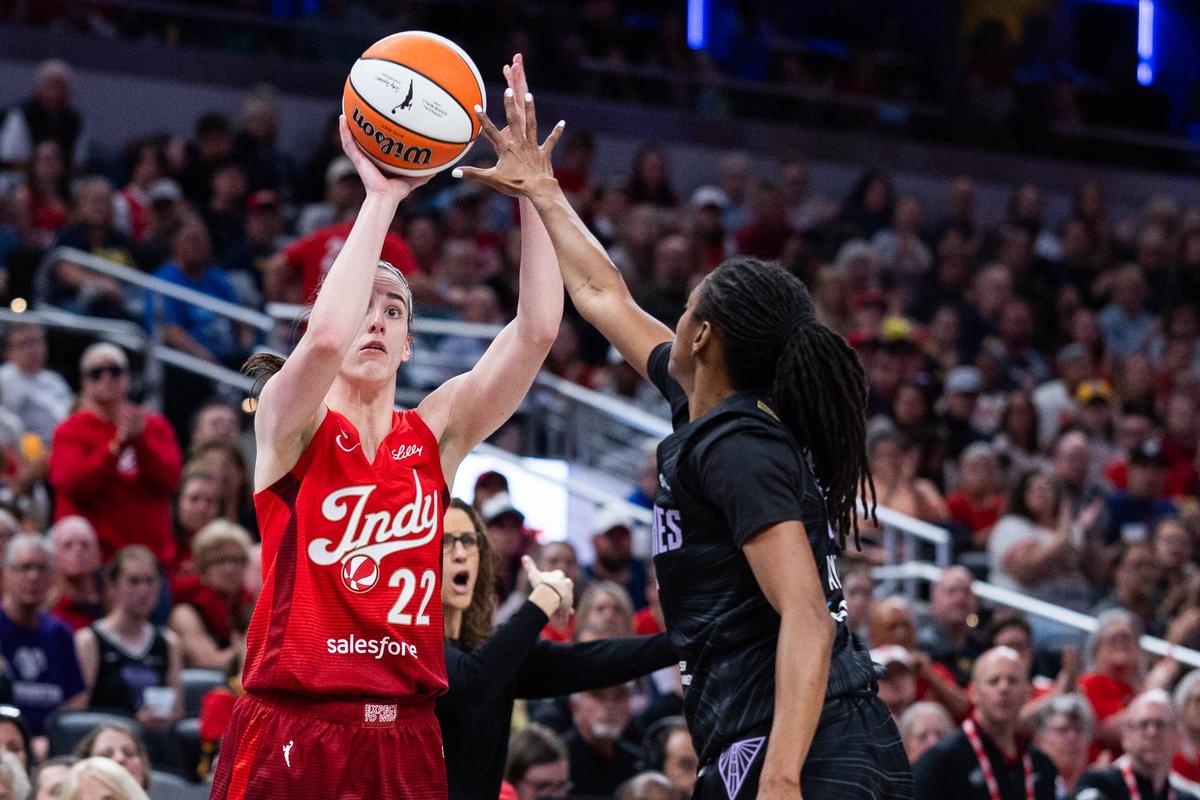  May 22, 2026; Indianapolis, Indiana, USA; Indiana Fever guard Caitlin Clark (22) shoots the ball while Golden State Valkyries guard Tiffany Hayes (15) defends in the second half at Gainbridge Fieldhouse. Mandatory Credit: Trevor Ruszkowski-Imagn Images 