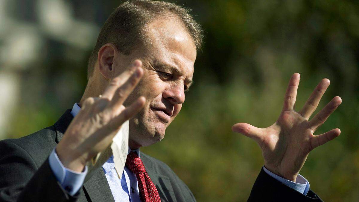 Initiative promoter Tim Eyman gestures as he talks to reporters in 2020, in front of the Temple of Justice at the Capitol in Olympia.