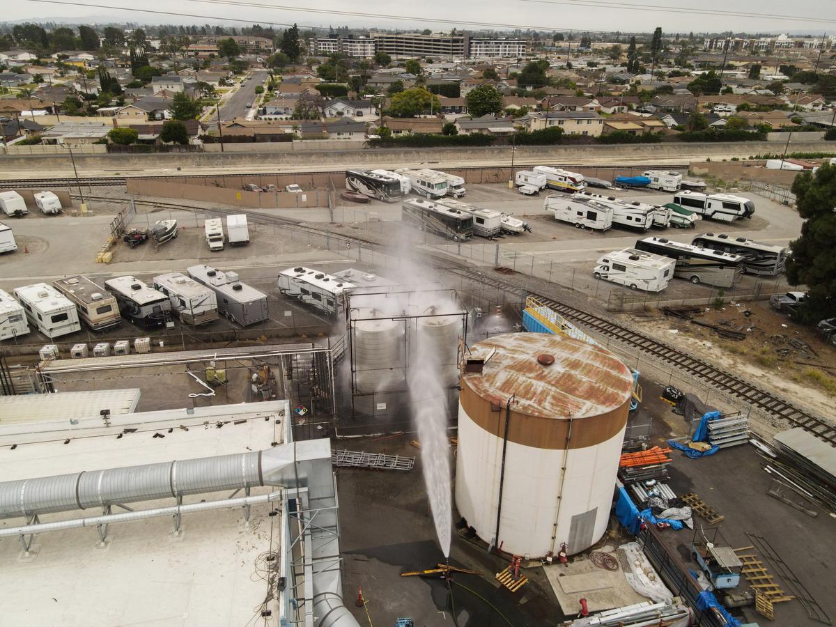 A drone view shows water being sprayed during a chemical incident involving a leaking tank of methyl methacrylate, a flammable liquid used in the aerospace industry, forcing an evacuation in the surrounding area, in Garden Grove, California, U.S., May 23, 2026. REUTERS/David Swanson