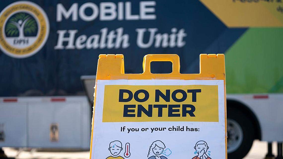A sign warning patients sits outside a mobile clinic offering free measles vaccinations in Spartanburg, South Carolina, on Feb. 6. A large measles outbreak in the state that sickened nearly 1,000 people, a vast majority of whom were unvaccinated children, was declared over Sunday.