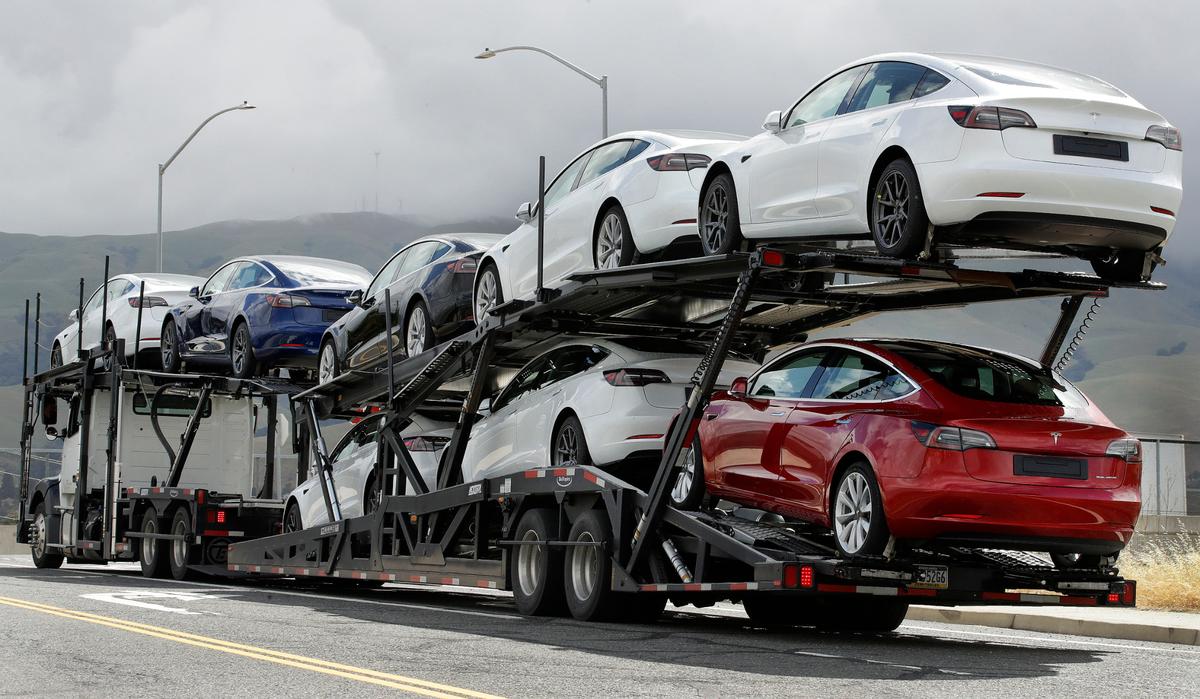 A truck loaded with Teslas departs the company’s plant in Fremont in 2020.