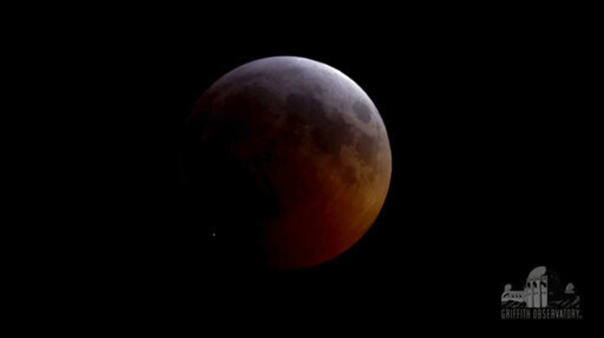 This image from video provided by Griffith Observatory in Los Angeles shows an impact flash on the moon, bottom left, during the lunar eclipse which started on Sunday evening, Jan. 20, 2019. Spanish astrophysicist Jose Maria Madiedo of the University of Huelva said Wednesday, Jan. 23, 2019, it appears a rock from a comet slammed into the moon. (Griffith Observatory via AP)
