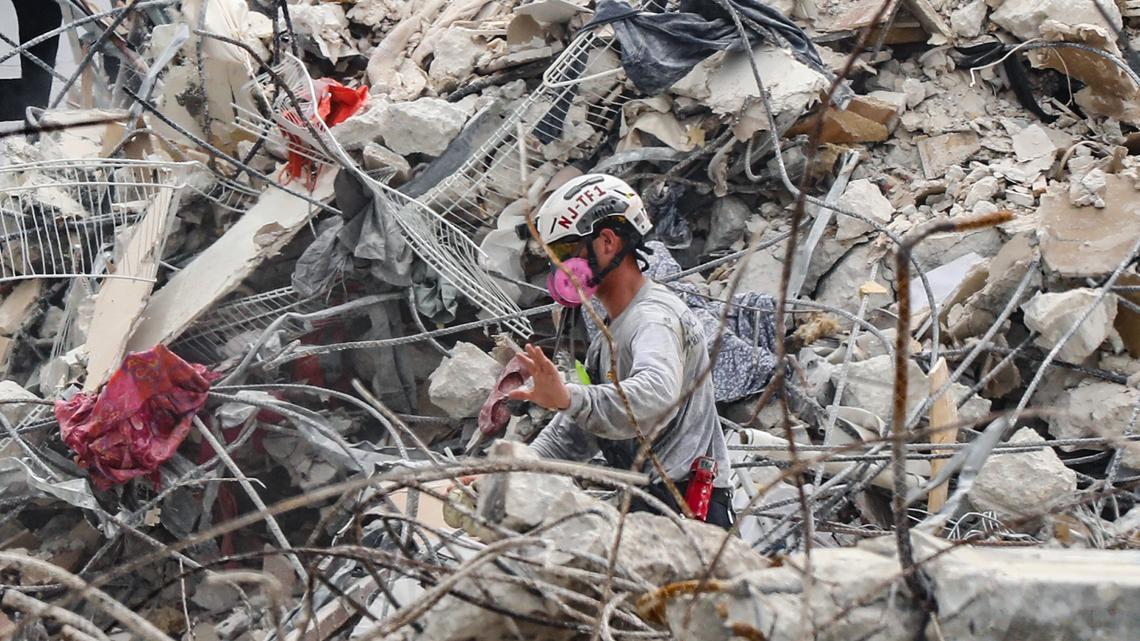 A search-and-rescue team member in the debris field of the 12-story oceanfront condo, Champlain Towers South, in Surfside on July 7, 2021.