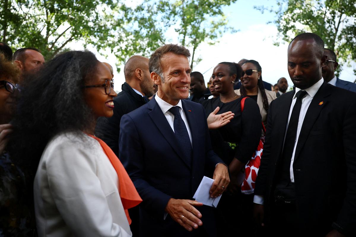 French President Emmanuel Macron talks with guests after the inauguration ceremony of a double stele artwork by artist Grada Kilomba, a new memorial site paying tribute to the victims of the Rwanda's genocide at the Habib-Bourgiba esplanade along the River Seine, in Paris, France, June 2, 2026. REUTERS/Sarah Meyssonnier/Pool